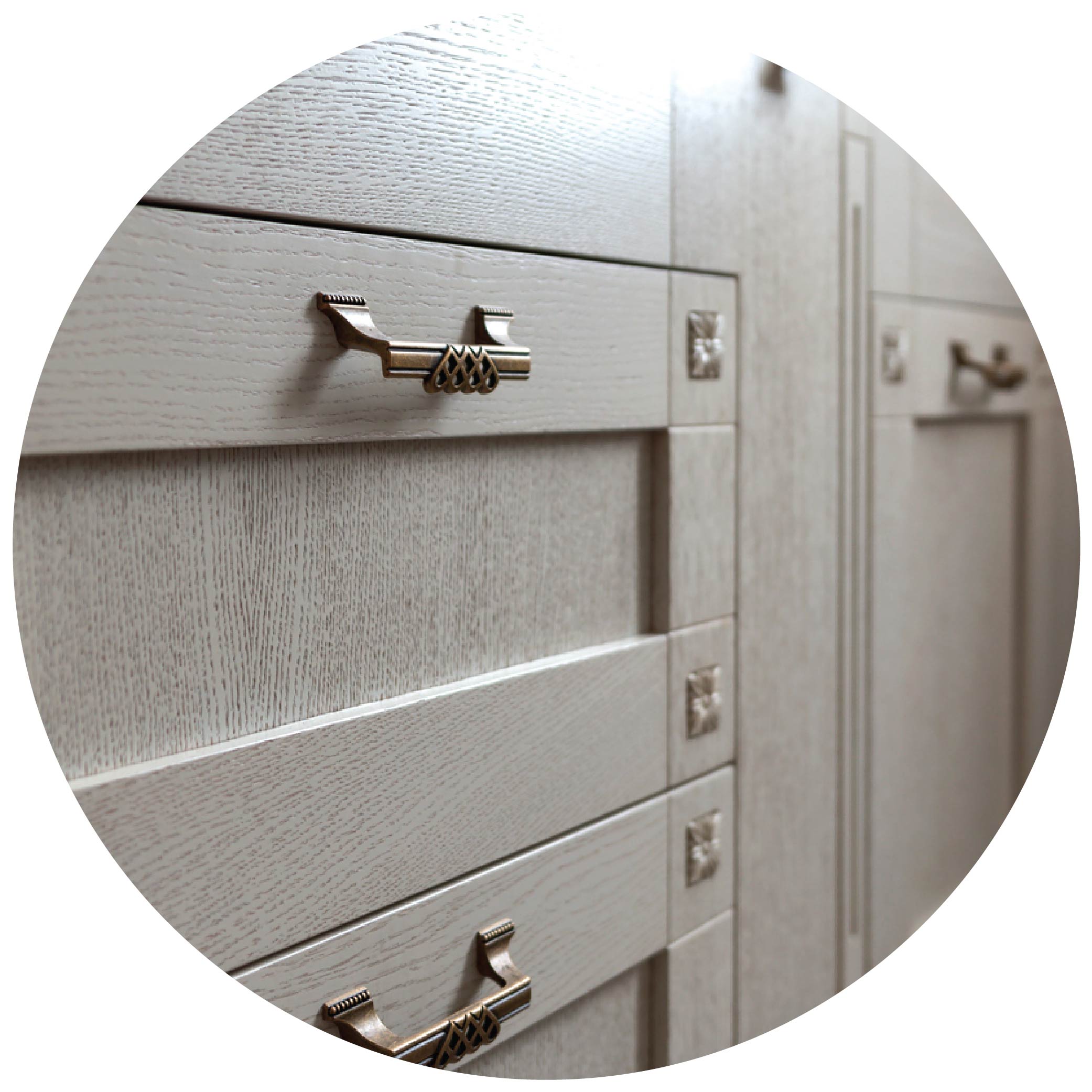 Closeup of gray kitchen cabinents with brushed knickle handles and corner bezels